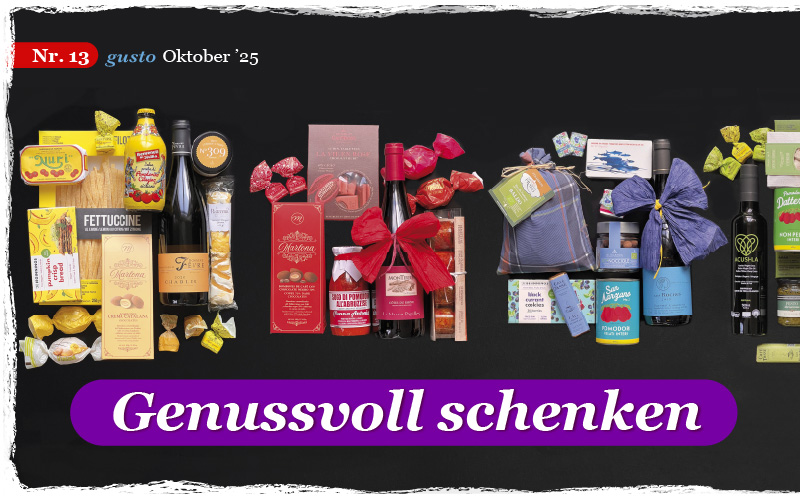 Auf einem schwarzen Hintergrund sieht man nach Farbtönen sortiert verschiedenste Geschenkartikel unter dem Titel Genussvoll schenken